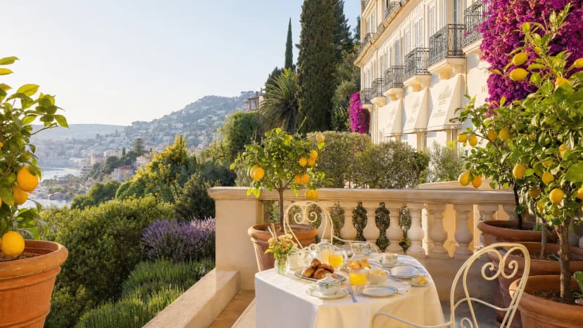 Hôtel Lemon Menton — sunny terrace with breakfast and lemon trees